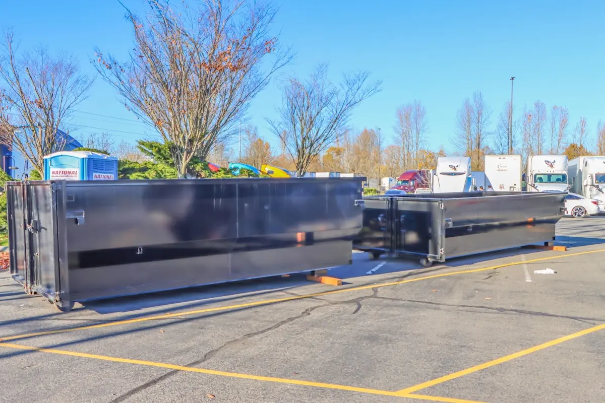 Professional dumpster rental service with roll-off container on residential driveway in Rossville